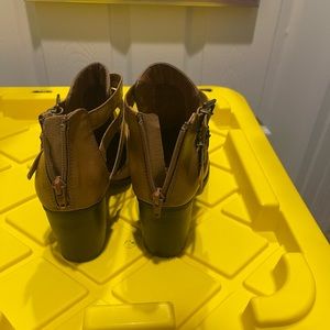 Brown ankle booties with partial foot showing